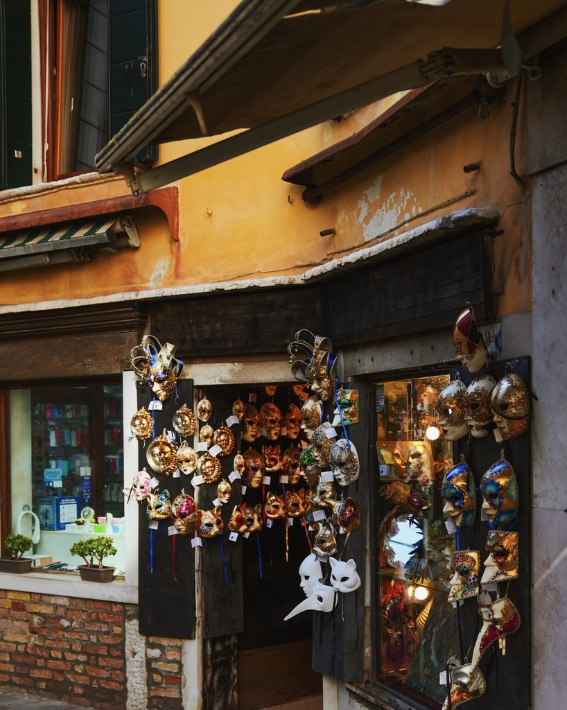 Traditional Venetian carnival masks displayed outside a mask shop in Venice