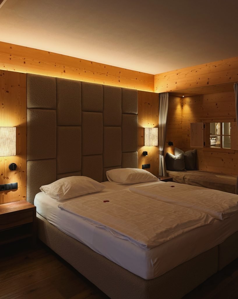 Deluxe Suite bedroom at Hotel Masl with natural wood walls and a king size bed