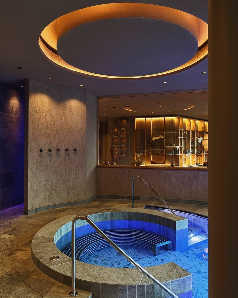 Indoor whirlpool under a glowing domed ceiling in the Hotel Masl spa